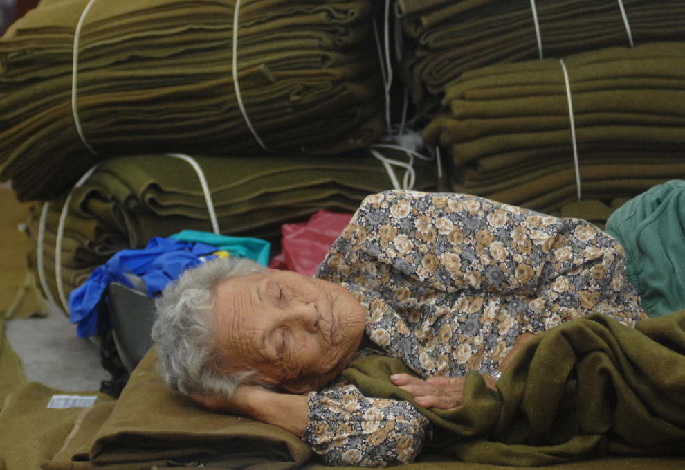 Женщина, спасаясь от тайфуна, отдыхает во временном центре эвакуации в Чиатунь в южном округе Тайваня Пиндун 9 августа 2009. (PATRICK LIN/AFP/Getty Images)
