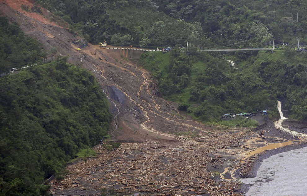 Огромный оползень стекает с горы на дорогу в округе Пиндун, южный Тайвань 10 августа 2009. (AP Photo)