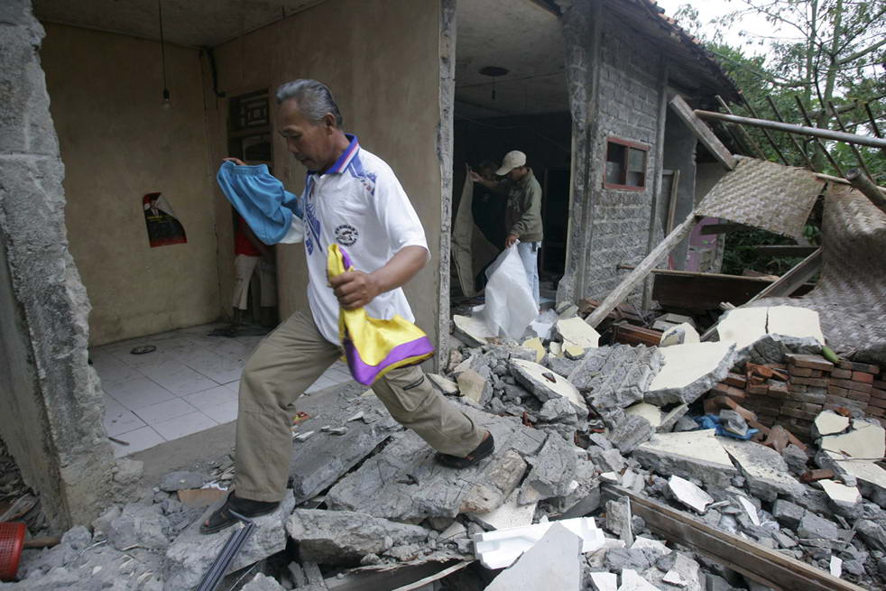 Жители деревни достают вещи из разрушенного землетрясением дома в Sindangbarang, Западная Ява, Индонезия, в четверг, 3 сентября. (AP/Irwin Fedriansyah)