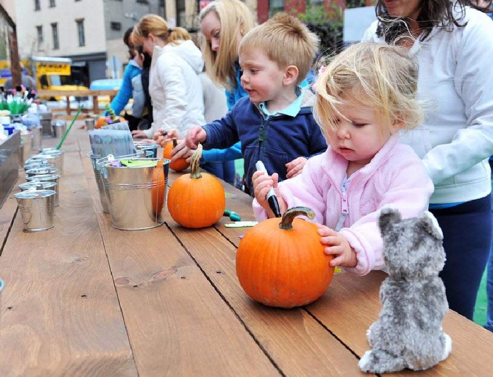Дети украшают тыквы на ярмарке на Манхэттене 23 октября в Нью-Йорке. (Henry S. Dziekan III, Getty Images)