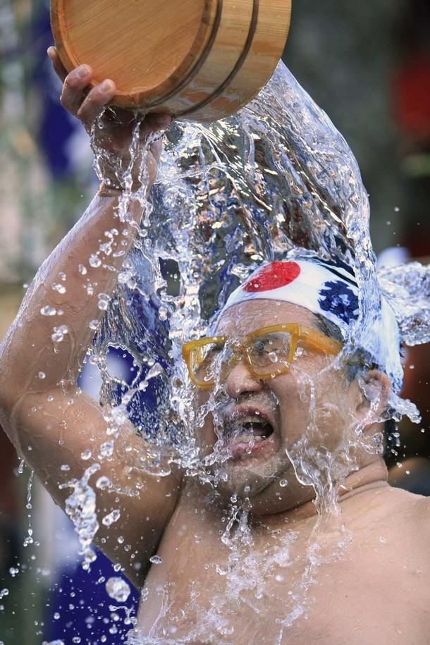 Ритуал обливания ледяной водой на выносливость проходит в храме ежегодно. Принимать такого рода ванны для теплолюбивых японцев дело не простое. (REUTERS/Kim Kyung-Hoon)